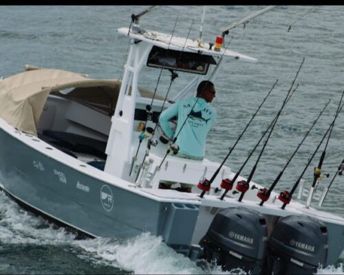 Angler reeling in a big catch during a sport fishing adventure in Tamarindo