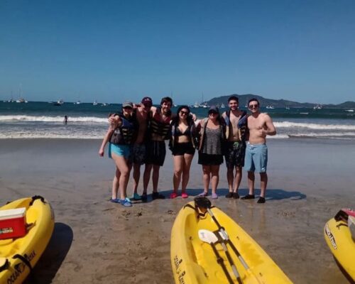 Tourists kayaking and snorkeling in the crystal-clear waters of Tamarindo